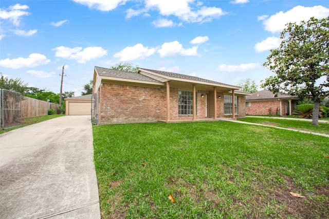 ranch-style home with fence, a detached garage, a front yard, and brick siding