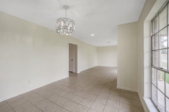 spare room featuring an inviting chandelier, recessed lighting, baseboards, and light tile patterned floors