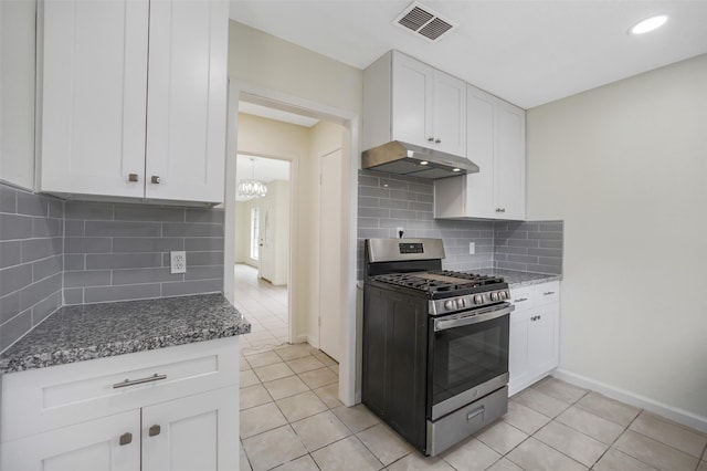 kitchen featuring light tile patterned flooring, a notable chandelier, white cabinetry, gas range, and under cabinet range hood