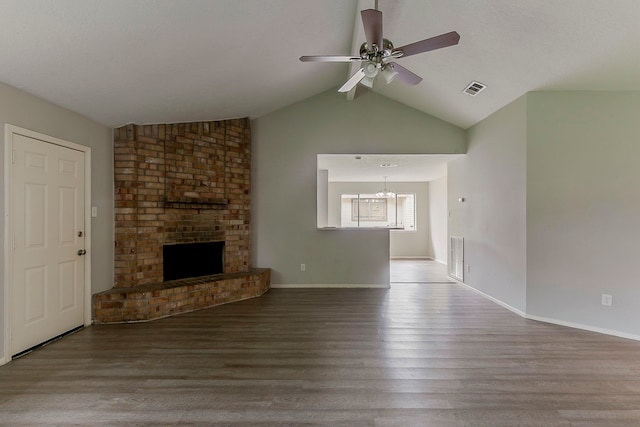 unfurnished living room featuring lofted ceiling, visible vents, a fireplace, wood finished floors, and ceiling fan with notable chandelier