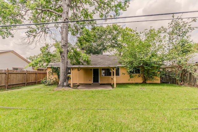 back of house with a patio, a fenced backyard, and a lawn