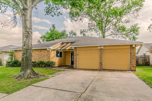 ranch-style house featuring brick siding, fence, a shingled roof, a garage, and concrete driveway