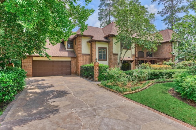 view of front of house with concrete driveway, brick siding, roof with shingles, and a garage