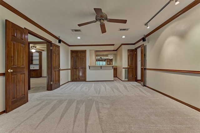 unfurnished living room featuring ornamental molding, ceiling fan, and visible vents
