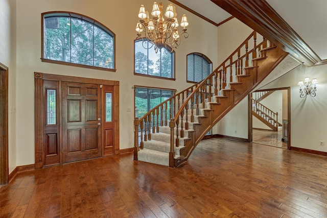 foyer entrance featuring stairway, baseboards, and hardwood / wood-style flooring