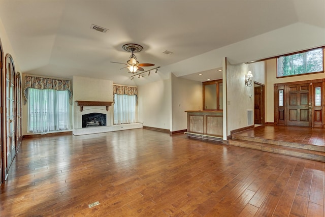 unfurnished living room with ceiling fan, plenty of natural light, and lofted ceiling