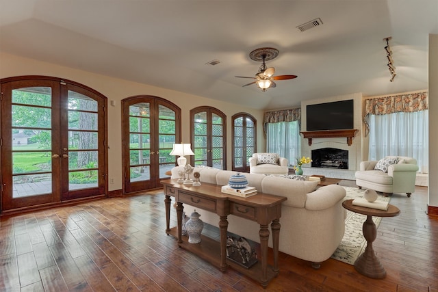 living area featuring ceiling fan, visible vents, french doors, and hardwood / wood-style flooring