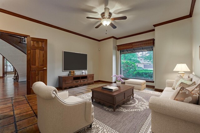 tiled living area with ceiling fan, plenty of natural light, and ornamental molding