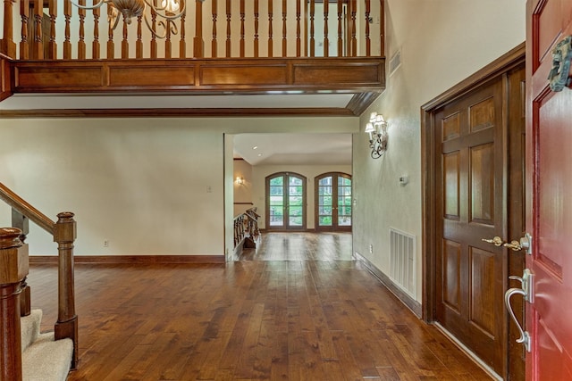 entryway featuring stairway, baseboards, dark wood-style floors, and visible vents