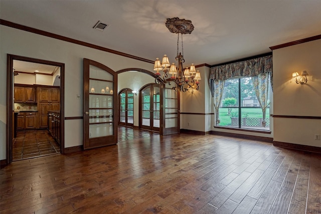 unfurnished dining area featuring crown molding, dark wood-style flooring, visible vents, and french doors
