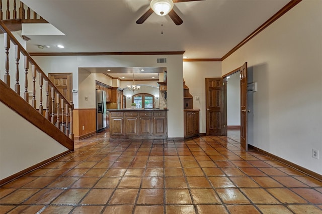 unfurnished living room featuring ceiling fan with notable chandelier, stairs, baseboards, visible vents, and ornamental molding