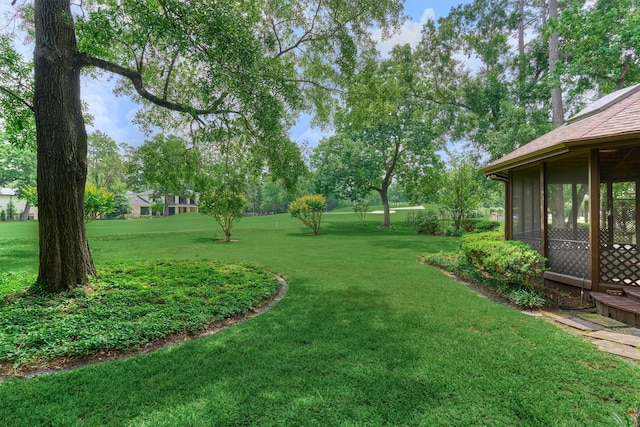 view of yard with a sunroom
