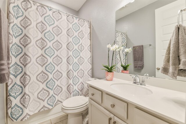 2379 Woodland Prairie Ln, Conroe, TX 77384 - bathroom with toilet, a shower with shower curtain, and vanity