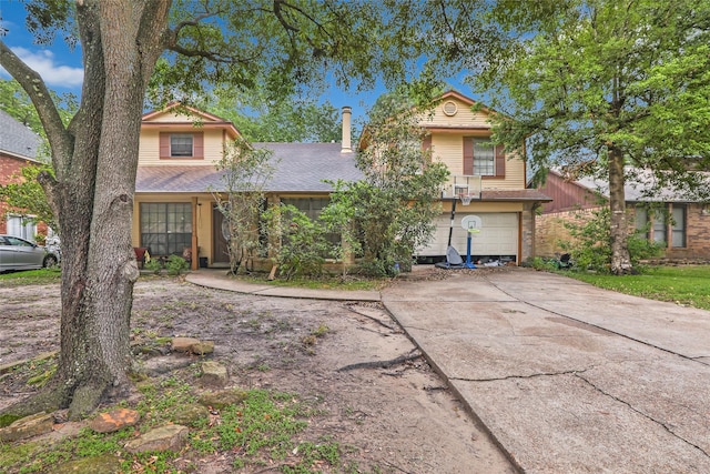 view of front of house with a shingled roof, driveway, and an attached garage