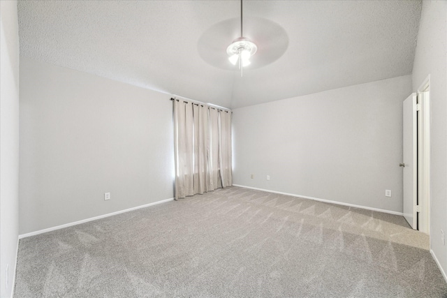 carpeted spare room with baseboards, ceiling fan, a textured ceiling, and lofted ceiling