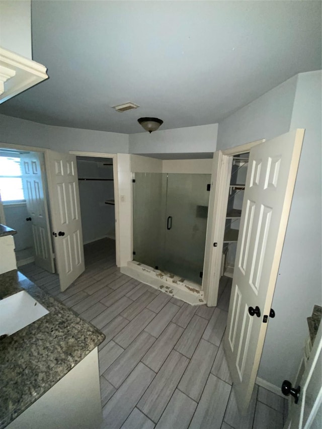 22006 Joshua Kendell Ln, Katy, TX 77449 - full bathroom featuring a shower stall, vanity, wood finish floors, and a spacious closet