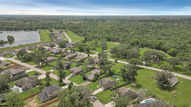 aerial view featuring a water view and a wooded view