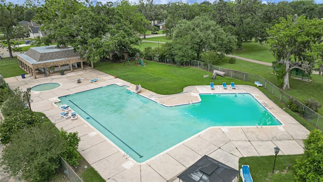 pool featuring fence, a yard, and a patio