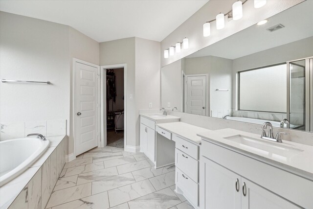 full bath featuring a bath, visible vents, vanity, baseboards, and marble finish floor