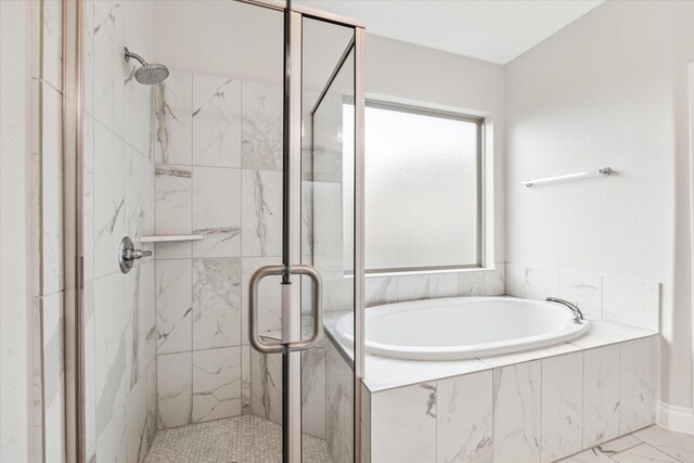 bathroom featuring a garden tub and a shower stall