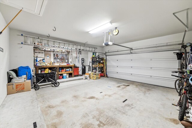 garage featuring a workshop area and a garage door opener
