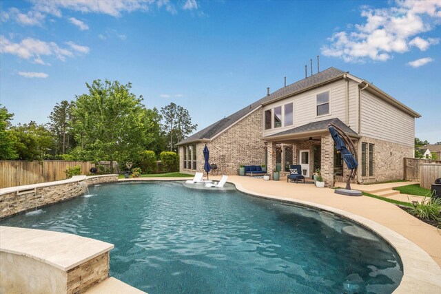 view of swimming pool featuring a fenced in pool, a fenced backyard, a patio area, and ceiling fan
