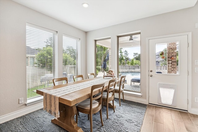 dining space featuring baseboards, recessed lighting, and a healthy amount of sunlight
