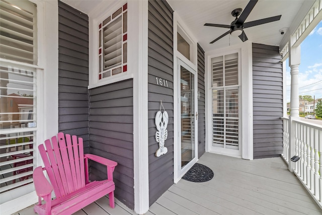 wooden terrace featuring a porch and ceiling fan