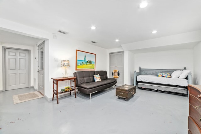 bedroom with finished concrete flooring, visible vents, and recessed lighting