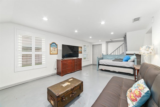 bedroom with visible vents, recessed lighting, and concrete flooring