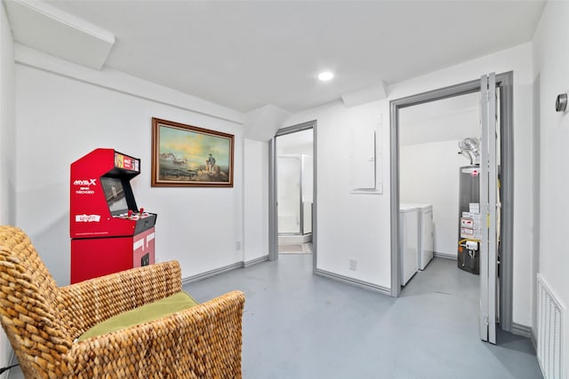 sitting room with recessed lighting, visible vents, water heater, washer and dryer, and finished concrete flooring