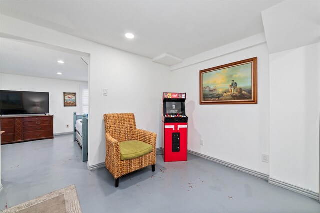 living area featuring concrete floors and recessed lighting