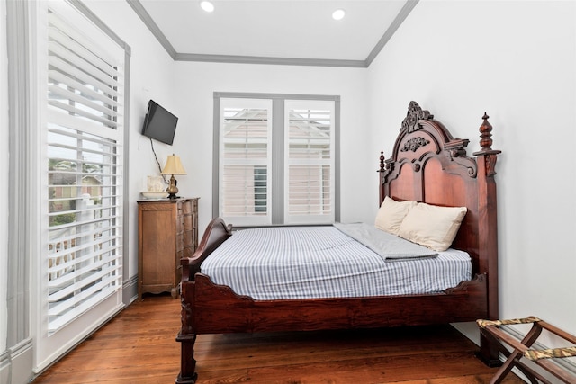 bedroom with ornamental molding, recessed lighting, and wood finished floors