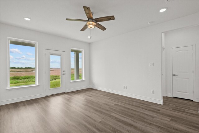 empty room featuring ceiling fan, recessed lighting, dark wood-style floors, and baseboards