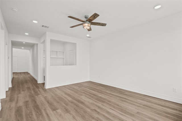 empty room with visible vents, ceiling fan, baseboards, recessed lighting, and wood finished floors