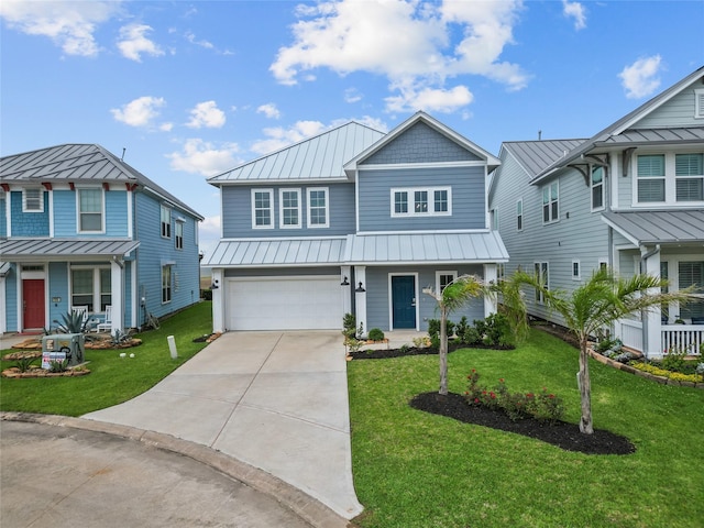 view of front of home featuring a standing seam roof, a front yard, concrete driveway, and an attached garage