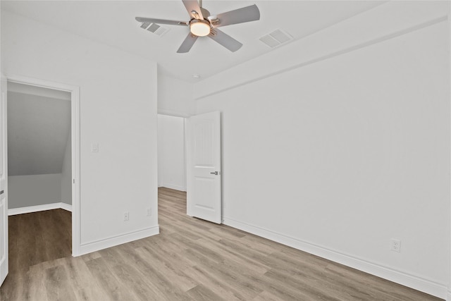 unfurnished bedroom with a ceiling fan, visible vents, wood finished floors, and baseboards