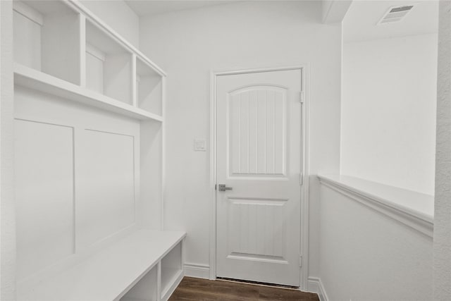 mudroom with baseboards, visible vents, and dark wood-style flooring