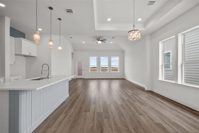 interior space with visible vents, recessed lighting, ceiling fan with notable chandelier, and a sink