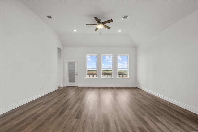 unfurnished living room featuring dark wood-style flooring, a ceiling fan, vaulted ceiling, and baseboards