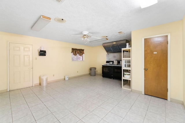 1561 US Highway 69 N, Woodville, TX 75979 - unfurnished living room with light tile patterned flooring, ceiling fan, a textured ceiling, and baseboards