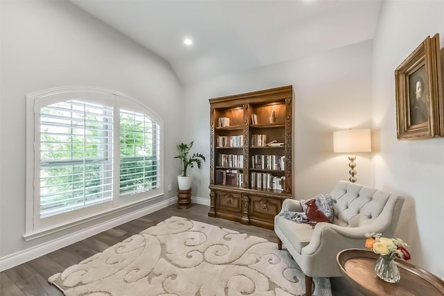 living area featuring recessed lighting, wood finished floors, lofted ceiling, and baseboards