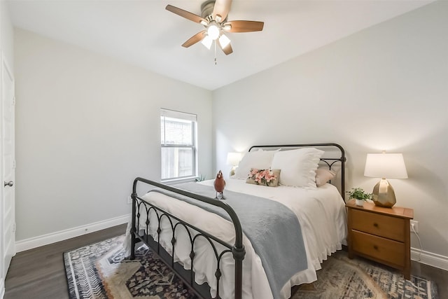 bedroom with baseboards, wood finished floors, and a ceiling fan