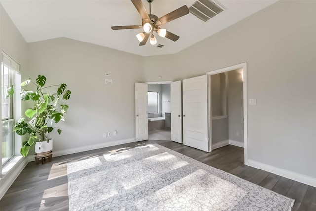 unfurnished bedroom with lofted ceiling, visible vents, and baseboards