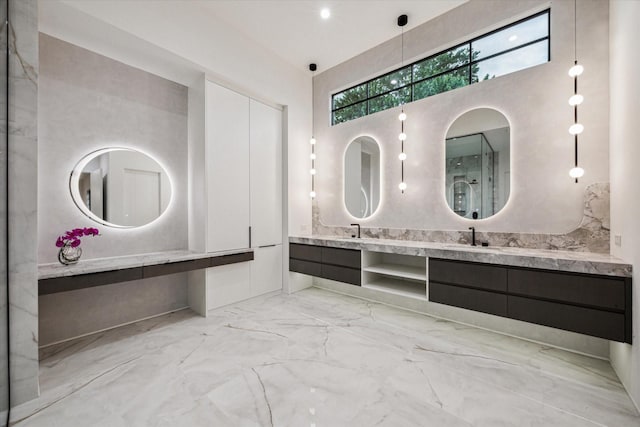 full bath with a towering ceiling, marble finish floor, and vanity