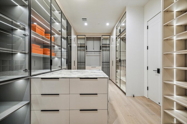 walk in closet with visible vents and light wood-type flooring