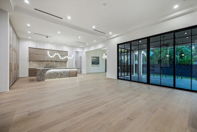 interior space with recessed lighting, access to outside, and light wood-style floors