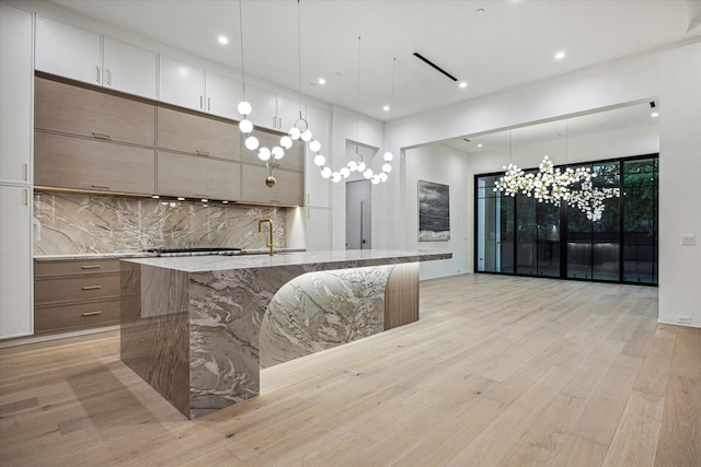 kitchen featuring recessed lighting, backsplash, modern cabinets, and light wood finished floors
