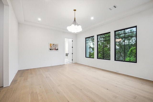 spare room with a chandelier, recessed lighting, visible vents, and light wood-style floors