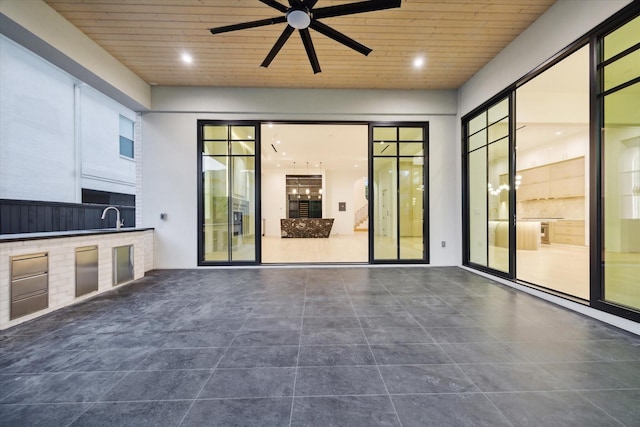 view of patio / terrace featuring an outdoor kitchen, ceiling fan, and a sink